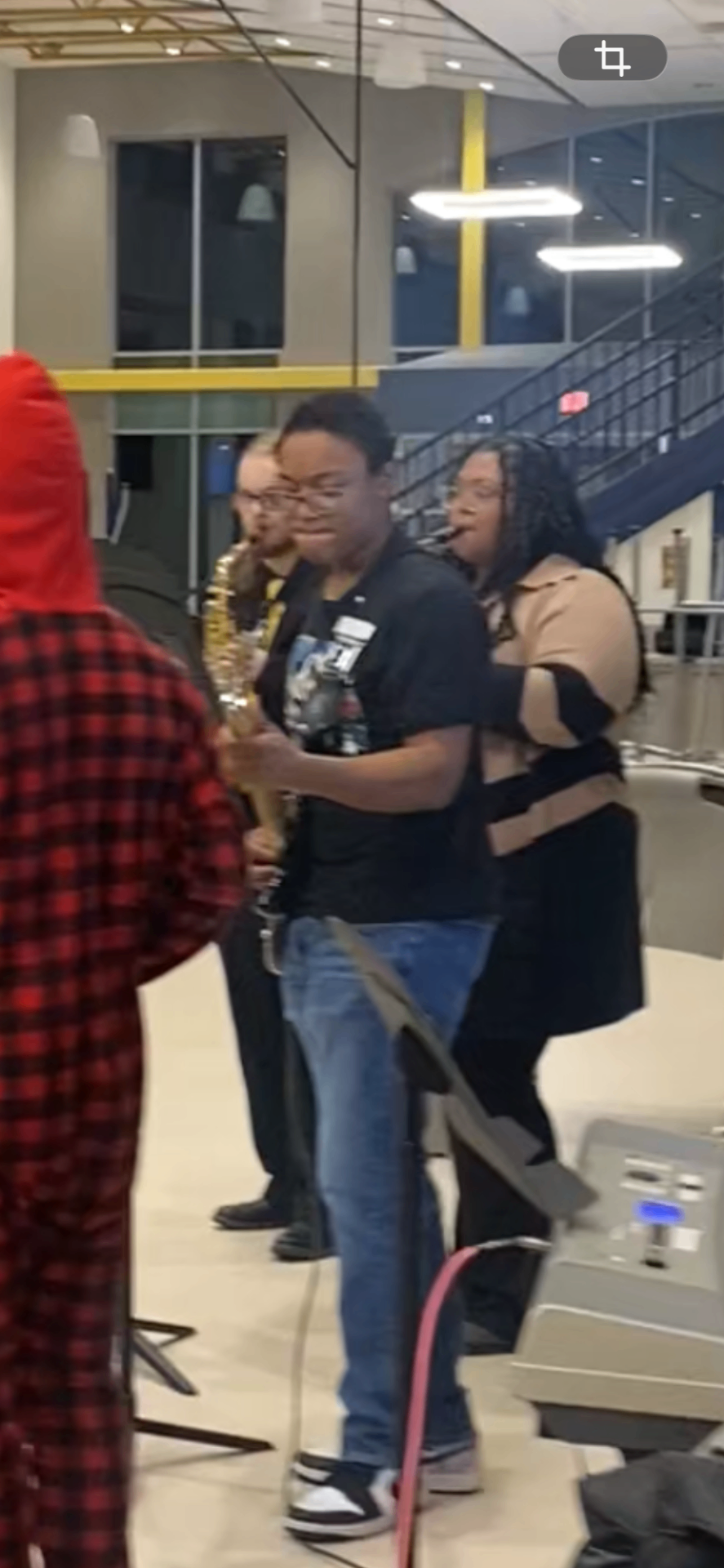 Teens performing music together at a community event supported by Earnie's Light